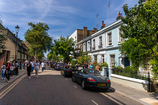 Portobello Road in central London with many people exploring the area near the house of writer George Orwell