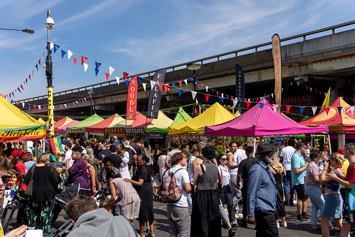 Street market at Portobello Road with many people visible in the image on a sunny day