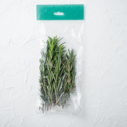 Fresh juicy Rosemary in market pack set, on white background, top view flat lay