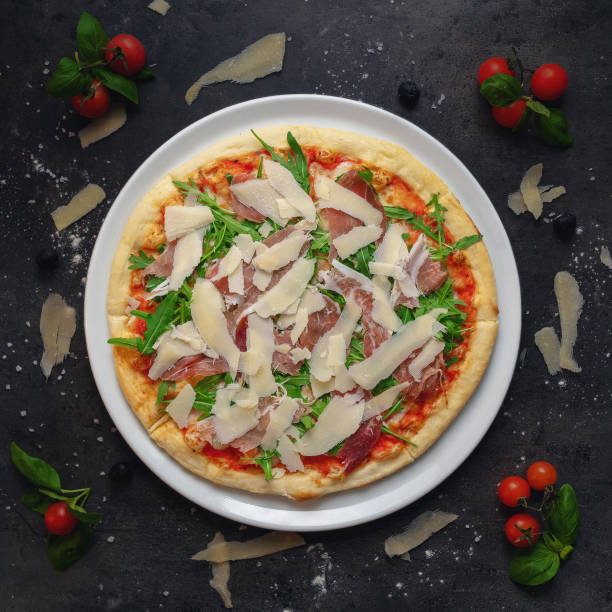 istock Delicious Italian Style Pizza With Prosciutto Ham and Arugula, Top Down Shoot, Appetizing Background 1414958662