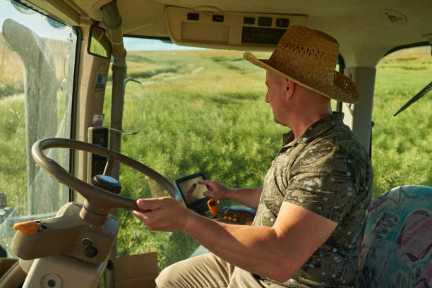istock Farmer with tractor in canola field 1414958846