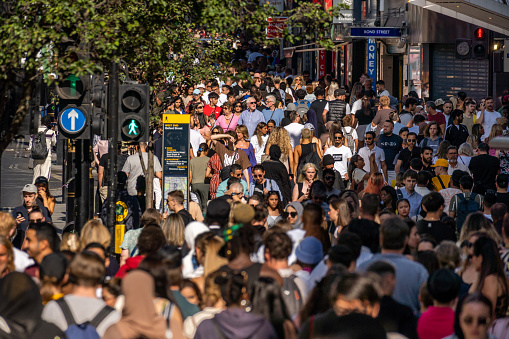 Crowded city streets in London on a hot summer day near the Bond street Underground entrance