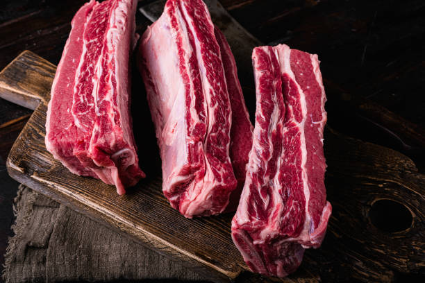 istock Short Ribs raw beef, on old dark  wooden table background, with copy space for text 1414958870
