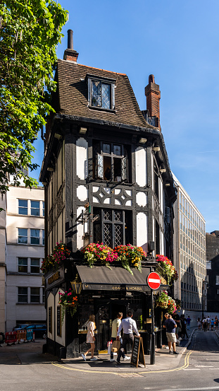 Historic timber framed pub in Soho distric of London with people out the front