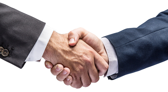 Business or political partnership concept.Handshake closeup on white background. Clipping path.