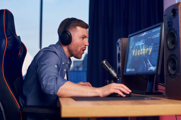 istock Focused on the playing. Man streaming FPS shooter game at home 1414961405