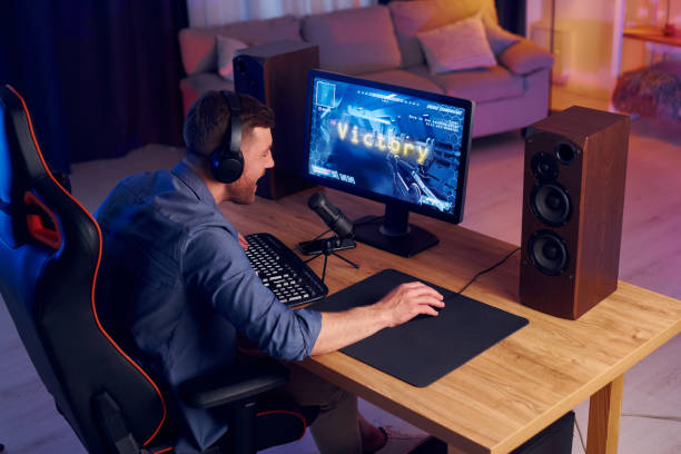 istock Focused on the playing. Man streaming FPS shooter game at home 1414961420