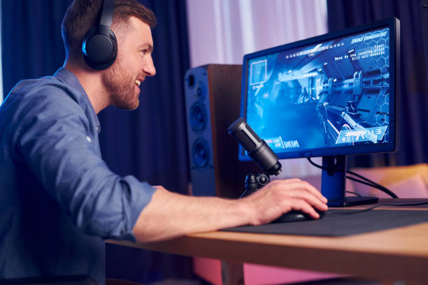 istock Focused on the playing. Man streaming FPS shooter game at home 1414961444