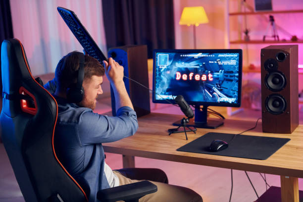 istock Losing the game. Online streamer playing FPS shooter game at home 1414962361