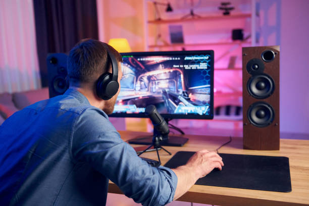 istock Nice gaming chair. Online streamer playing FPS shooter at home 1414962474