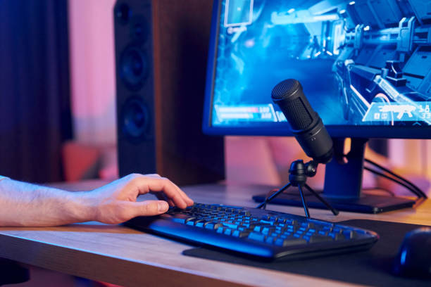 istock Using the keyboard. Online streamer playing FPS shooter game at home 1414962647