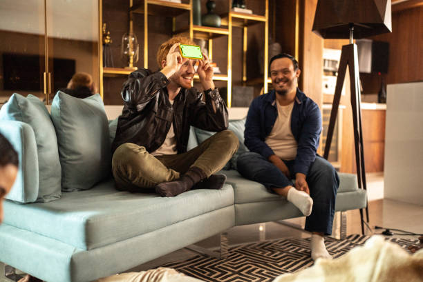 istock Friends playing guessing game at home - including a person with special needs 1414962733