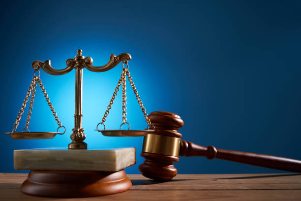 istock gavel hammer and balance scale against blue background 1414963011