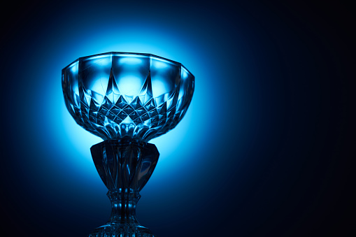 light on the crystal trophy against blue background