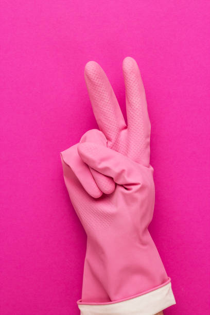 istock hand in glove shows v sign 1414963671