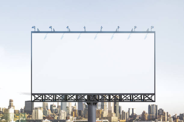 istock Blank white billboard on city buildings background at daytime, front view. Mockup, advertising concept 1414964567
