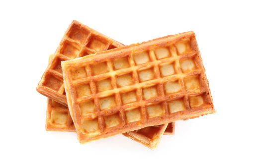 Delicious Belgian waffles on white background, top view