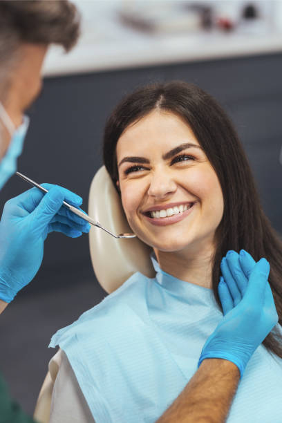 Young happy woman during dental procedure at dentist's office. stock photo