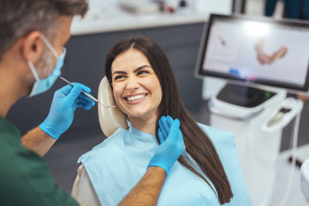 istock Dentist examining patient's teeth in clinic. 1414968591