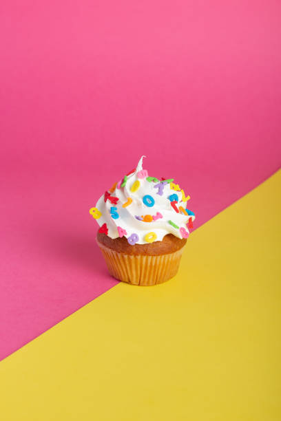 istock Cupcake on a pink and yellow background. 1414968762