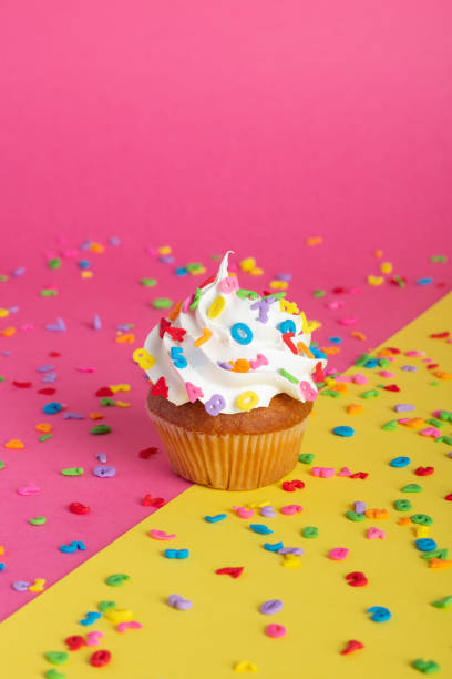istock Cupcake on a pink and yellow background. 1414968774