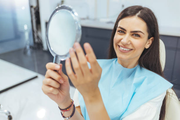 istock Young woman admiring her teeth after having a dental procedure done 1414969406