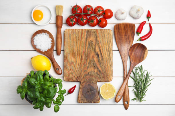istock Flat lay composition with cooking utensils and fresh ingredients on white wooden table 1414969438