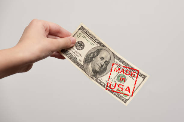 Made in USA one hundred dollar bill with stamp "Made in USA" in hand one hundred dollar stamp stock pictures, royalty-free photos & images