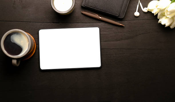 istock Top view office desk with digital tablet, coffee cup and notebook. 1414970015