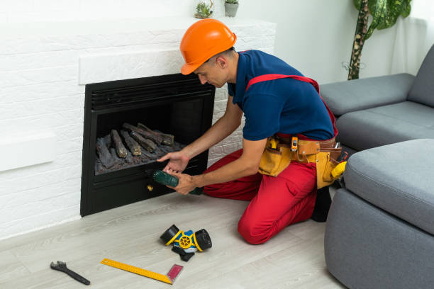 istock Professional technician installing electric fireplace in room. 1414971590