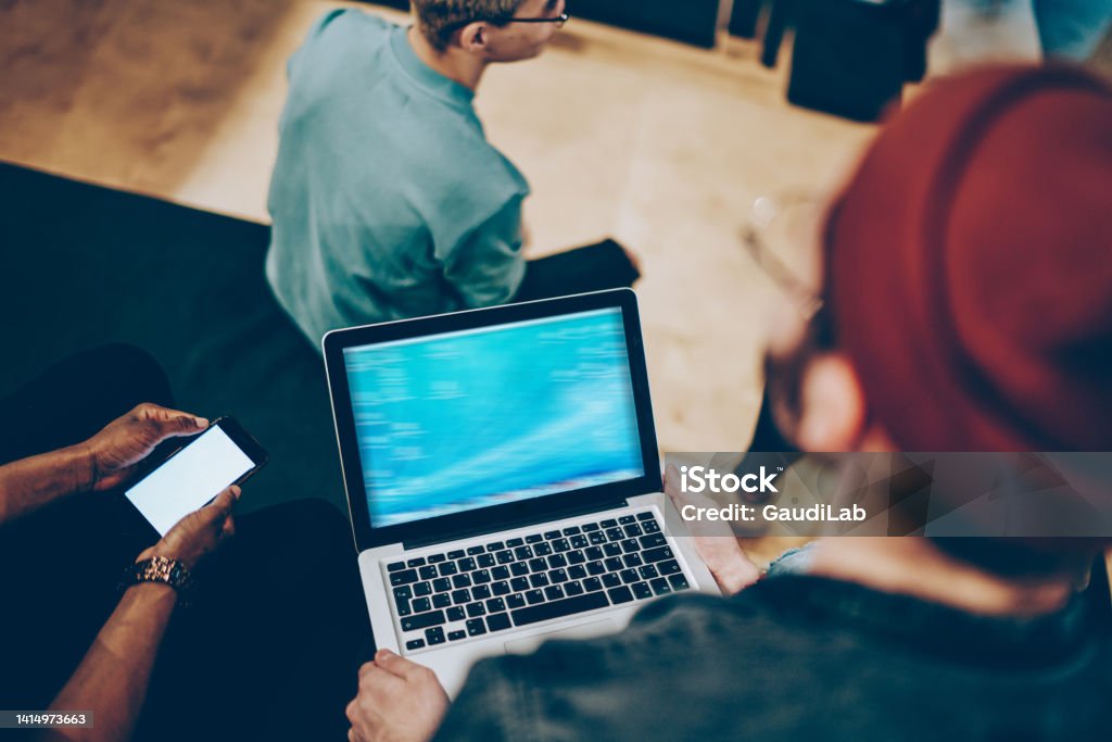 Browsing Network Back View Of Millennial Guys Using Modern Technology For Browsing ...