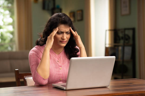 istock woman using laptop at home stock photo 1414973755