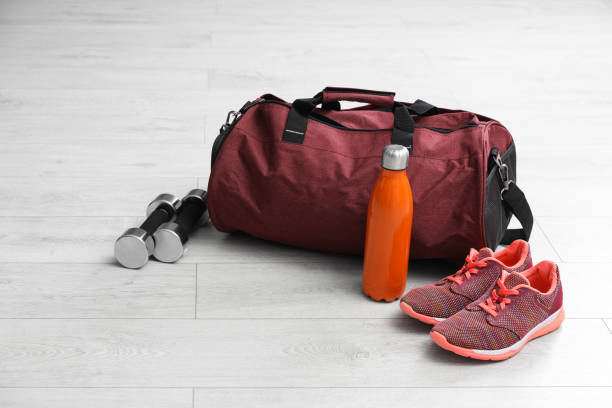 istock Sports bag and gym stuff on white floor 1414975468