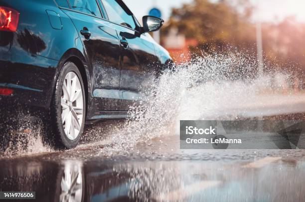 Car Driving Through The Puddle And Splashing By Water Stock Photo - Download Image Now