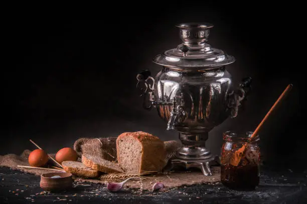 still life with a samovar depicted on it, bread, eggs, honesty, salt and everything on drapery