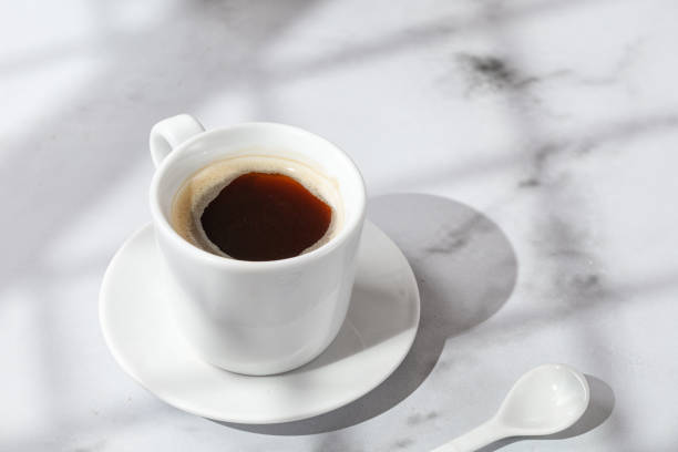 istock Cup with Coffee, hot drink in a mug. Mmarble background with window shadow. Sunny, sunshine. Arabica in coffee cup. 1414977619