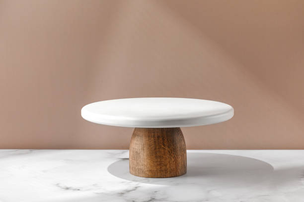 istock White empty Cake stand, Bakery utensil and dishware. Podium for cake. Minimalist mock up for cake with window shadow. 1414979646