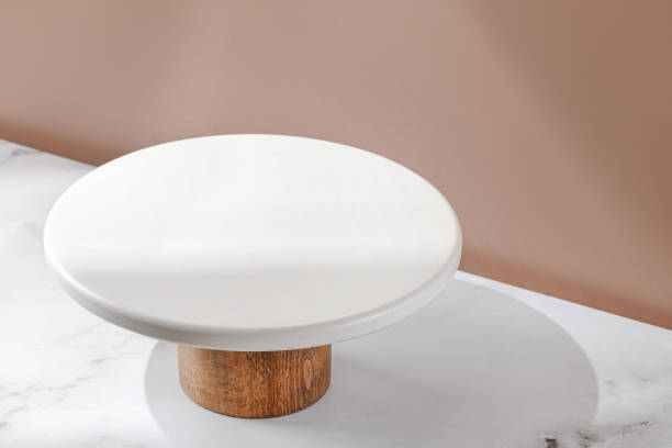White empty Cake stand, Bakery utensil and dishware. Podium for cake. Minimalist mockup for cake with window shadow. White empty Cake stand, Bakery utensil and dishware. Podium for cake. Minimalist mockup for cake with window shadow. Design Template. Front diagonal view cake models stock pictures, royalty-free photos & images