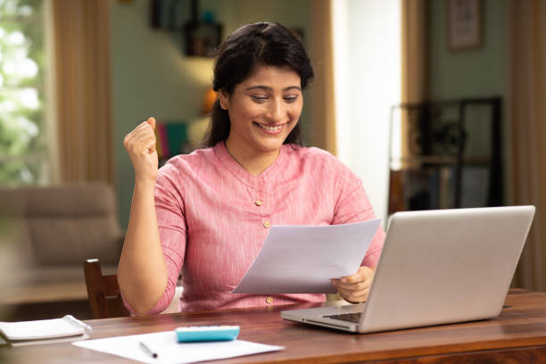 istock indian woman holding reading document sit at table stock photo 1414980959