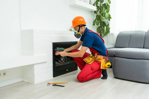 istock Professional technician installing electric fireplace in room. 1414981963