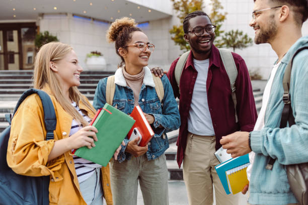 Multi-ethnic group of students talking in front of University stock photo