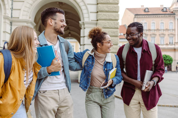 istock Multi-ethnic group of students talking in front of University 1414982114