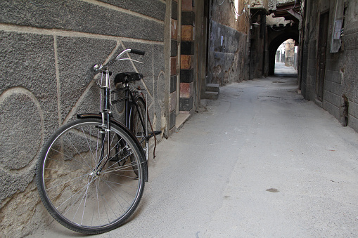 Valencia, Spain - October 9, 2023: Bicycle hooked to pole with missing rear wheel. Most likely the owner left it there and took the wheel to fix a flat tire