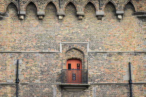 Brugge, Belgium - July 4, 2022: Small red door in the Belfry of Bruges