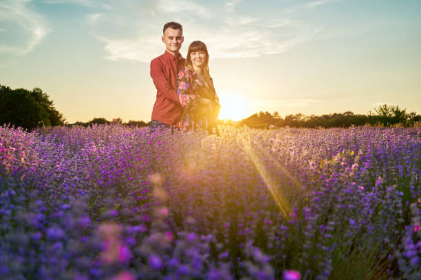 istock Young couple in a lavender field at sunset 1414984025