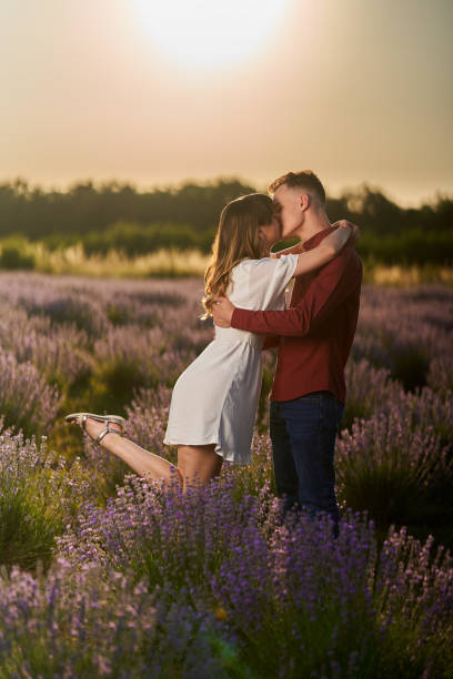 istock Young couple in a lavender field at sunset 1414984115