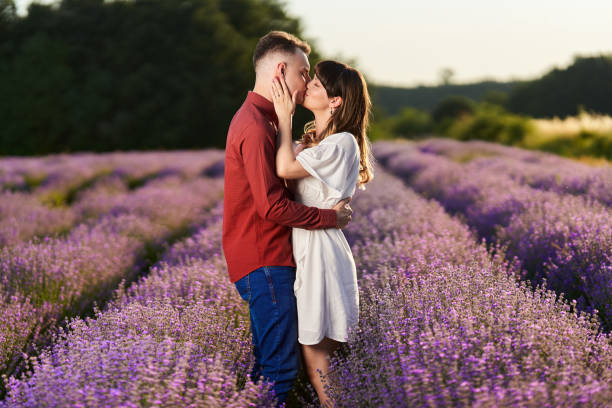 istock Young couple in a lavender field at sunset 1414984130