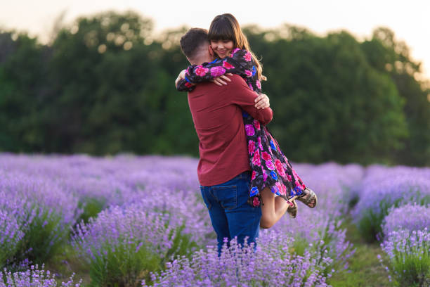 istock Young couple in a lavender field at sunset 1414984208