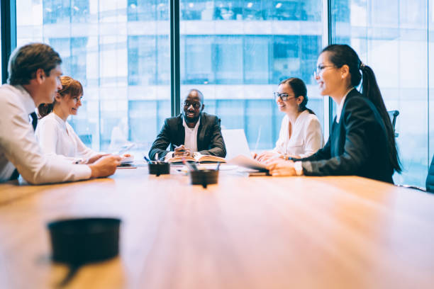 istock Corporate employees sitting at meeting table having conference brainstorming for discussing business ideas and create startup strategy for progressive project, concept of briefing for search solutions 1414984426