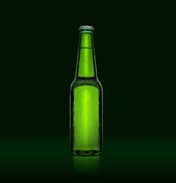 istock 3D render. Single green beer bottle without brand designation. Full glass bottle covered with water drops against green illuminated background. Alcoholic drinks and refreshment concept 1414986149